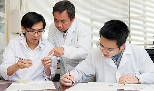 PGS Trần Đăng Xuân (giữa) và nghiên cứu viên tại phòng thí nghiệm. 