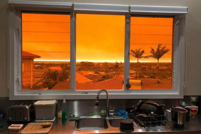 Bầu trời đỏ cam nhìn từ cửa sổ một ngôi nhà ở Lighthouse Beach