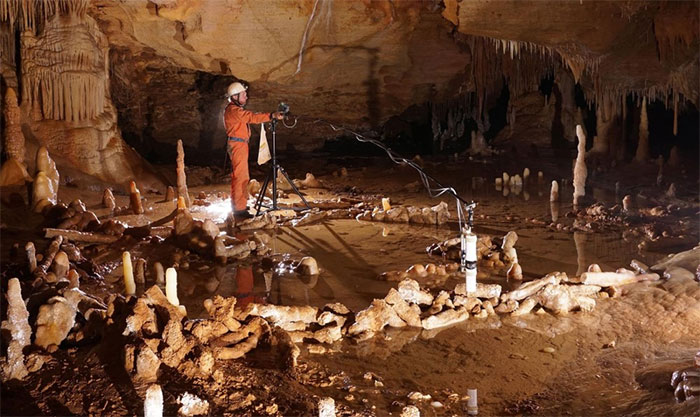 Một người đang thực hiện phép đo vòng đá bên trong hang động Bruniquel ở Pháp
